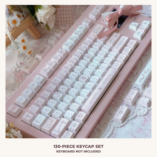 Love-themed pink and white keycaps in a styled desk setting; keyboard and accessories not included.